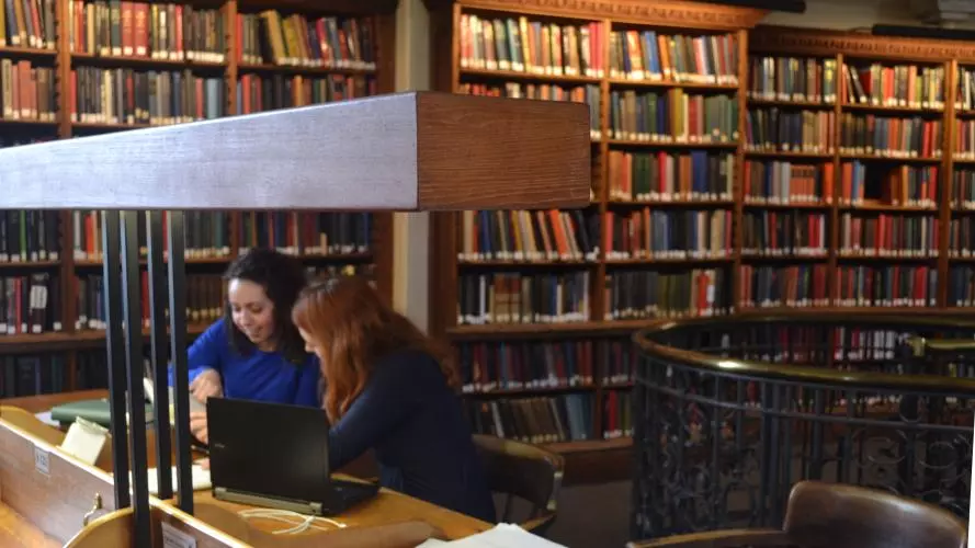 Two students studying in the History Faculty Library