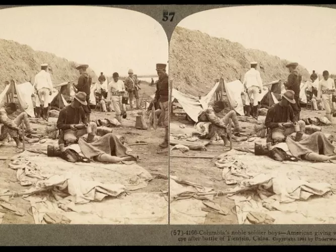 American soldier helping a Japanese soldier during the Boxer Rebellion ,1901, photography by James Ricalton.