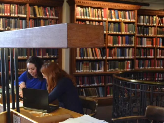 Two students studying in the History Faculty Library